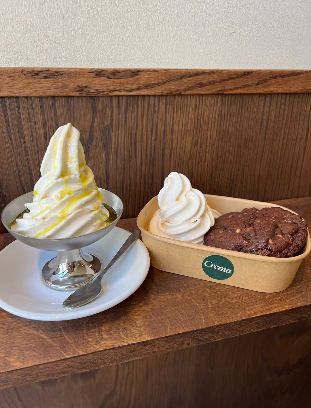 Artisanal soft serve with olive oil next to a chocolate cookie at Crema
